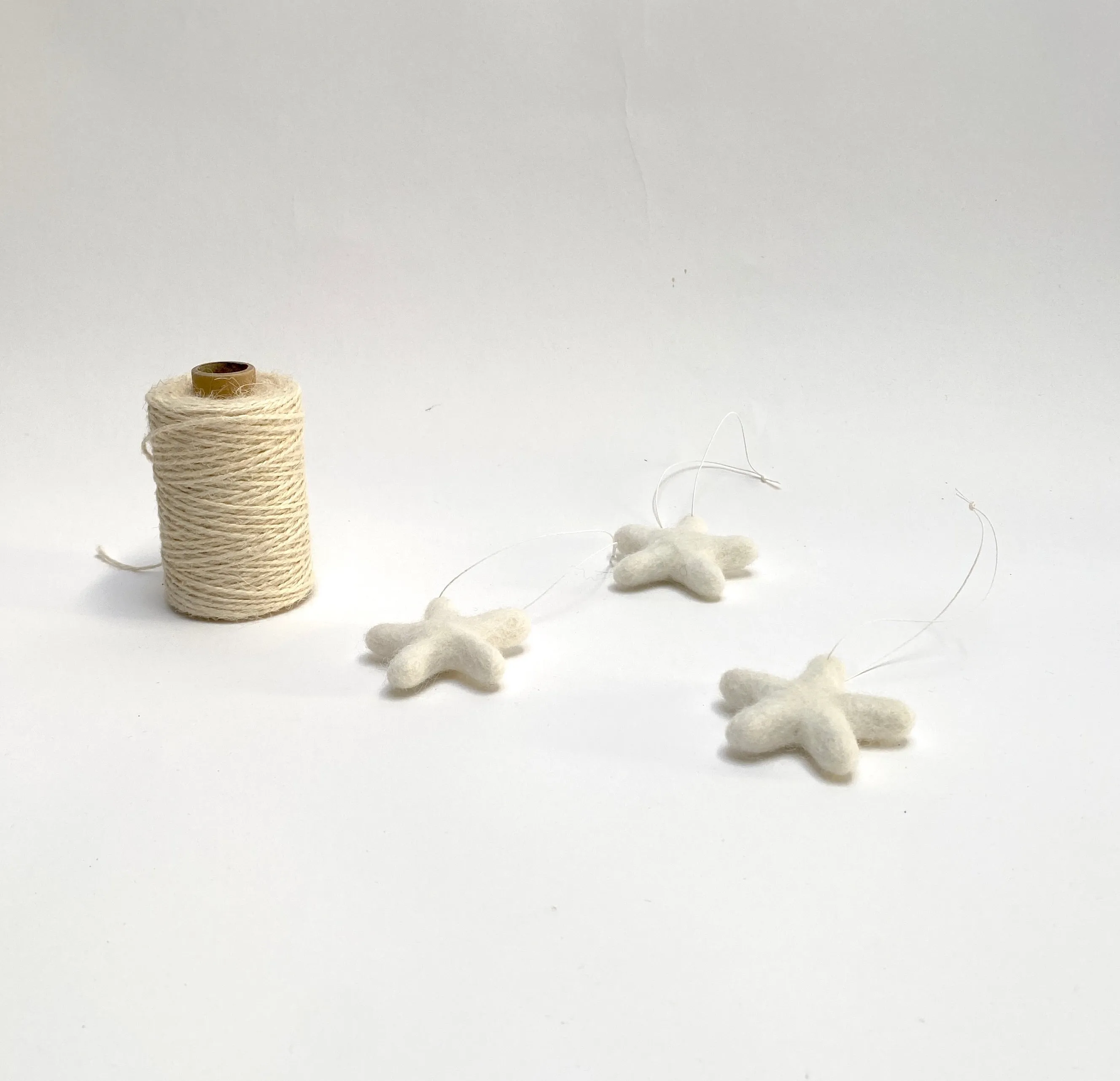 set of 3 felted wool stars (in cotton bag)