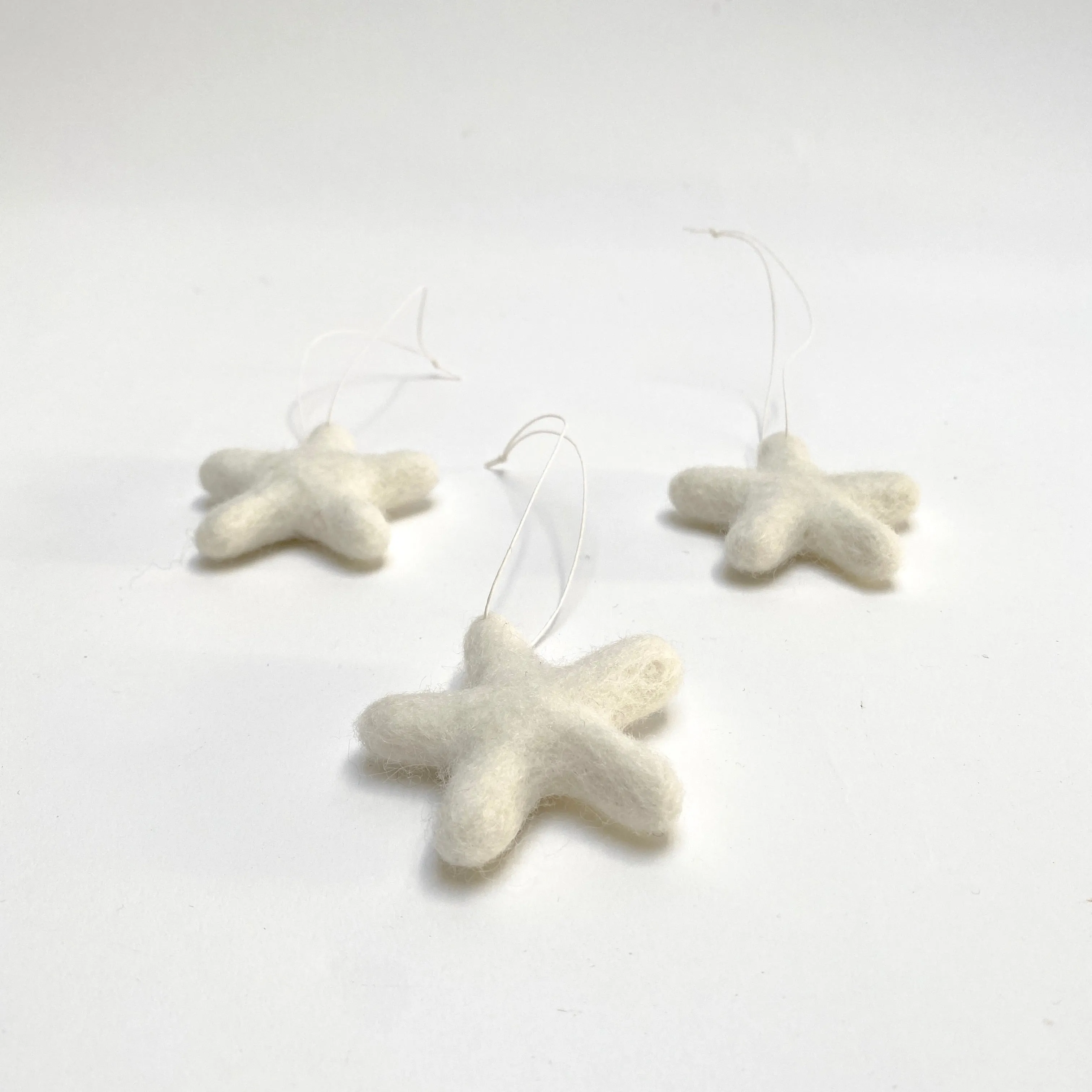 set of 3 felted wool stars (in cotton bag)